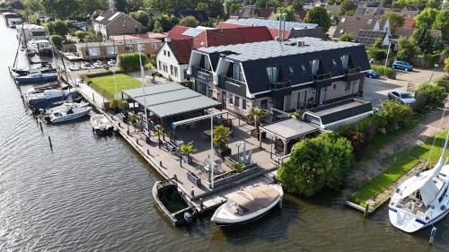 an aerial view of a house with boats in the water at Appartementen De Helling 44 in Heeg