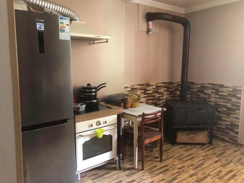 a kitchen with a stove and a table in it at Matarta in Mestia