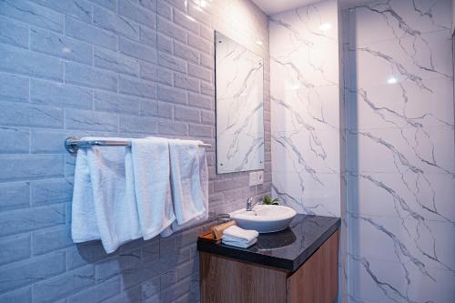 a bathroom with a sink and a mirror at D'House Seminyak in Seminyak