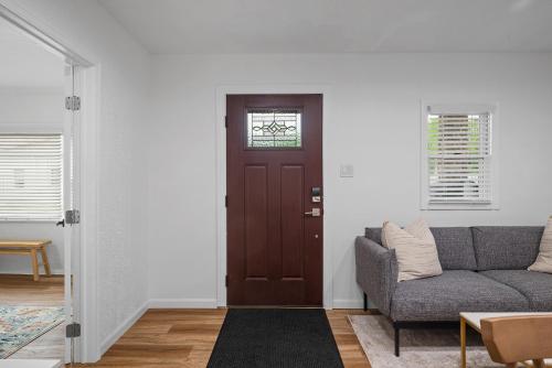 a living room with a couch and a door at Modern & Spacious Four Bedroom Apartment in Gibsonia, Pittsburgh, Unit 1 in Bakerstown