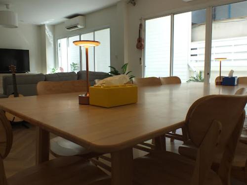 a dining room table with a yellow box on top at Areava Pool Villa Cha-am บ้านพักชะอำ พูลวิลล่า ติดชายหาดชะอำ in Cha Am