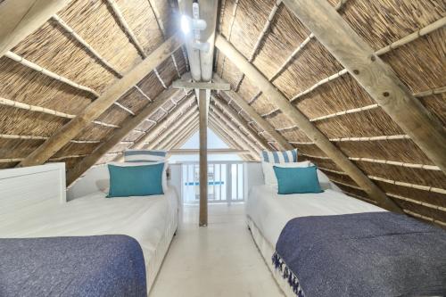 two beds in the attic of a room at Cape Creek Cottage in Struisbaai