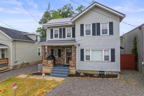 a gray house with a driveway at Modern & Spacious Four Bedroom Apartment in Gibsonia, Pittsburgh, Unit 1 in Bakerstown