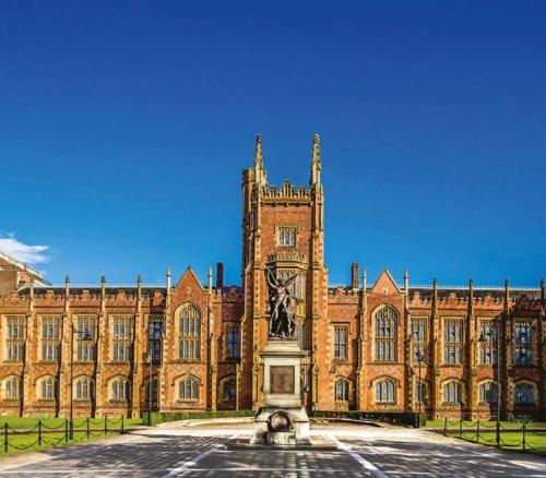 a large building with a clock tower in front of it at Double bedroom on the Ormeau Road in Belfast