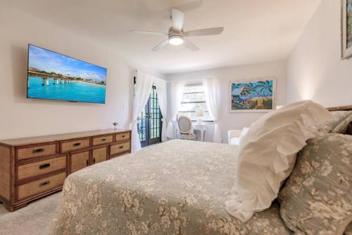 a bedroom with a bed and a ceiling fan at Park Shore Resort Deluxe Condo, water views 232 in Naples