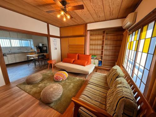 a living room with a couch and a table at Vintage House Cortile of HIMAWARI in Matsudo