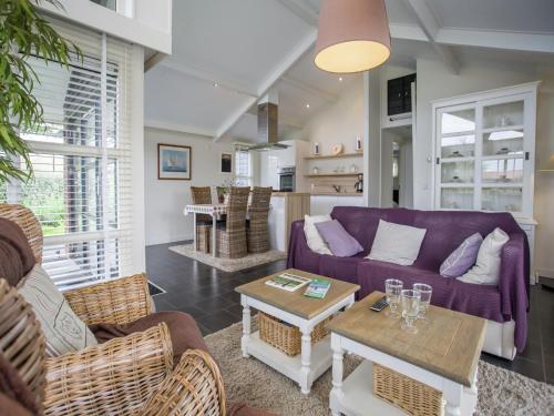 a living room with a purple couch and chairs at Chalet in Kattendijke near Eastern Scheldt in Kattendijke