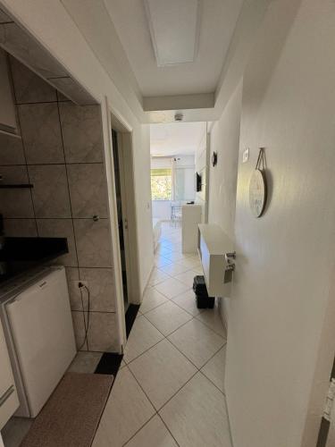a bathroom with a shower and a sink and a toilet at Charmoso Flat 309 Cavalinho Branco in Águas de Lindoia