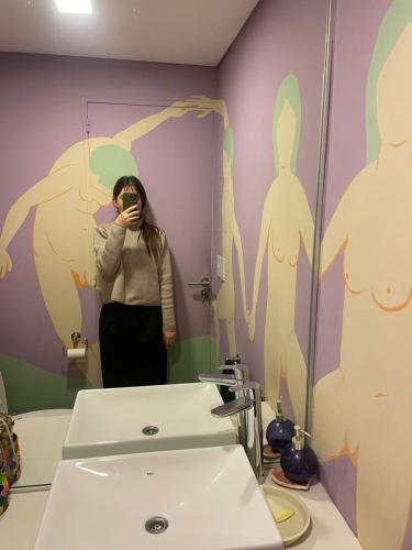 a woman taking a picture of herself in a bathroom mirror at depto vista laguna in San Fernando