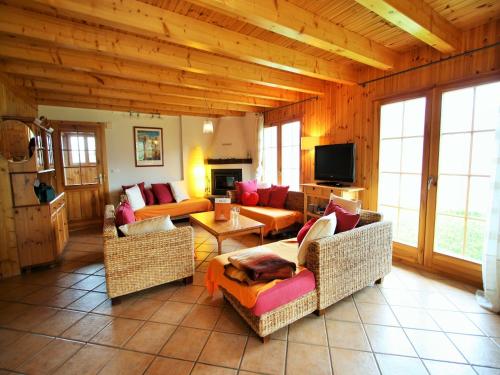 a large living room with couches and a tv at Chalet in Rhone Valley near Ski Lift in Les Collons