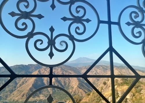 a view of the mountains through a window at Vista Alcantara - Wellness Mountain-Top Retreat in Motta Camastra