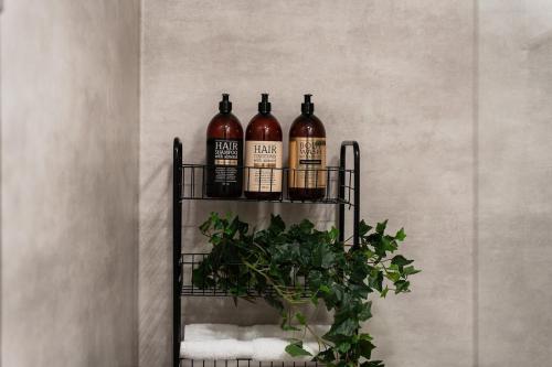 a shelf with three bottles of wine on it at Guestly Homes - Charming 4BR Villa in central Piteå in Piteå