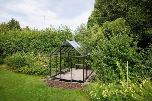 a gazebo in the middle of a garden at Guestly Homes - Charming 4BR Villa in central Piteå in Piteå