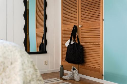 a room with a door with a purse and shoes at Guestly Homes - Charming 4BR Villa in central Piteå in Piteå