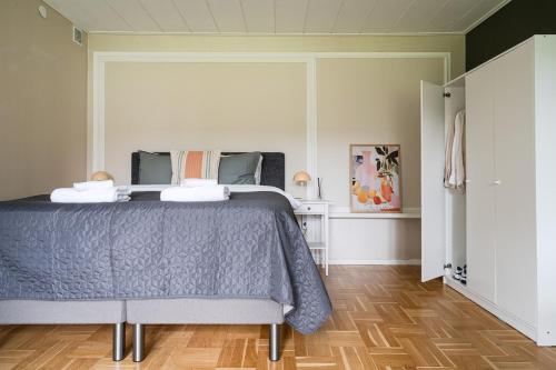 a bedroom with a bed with a blue comforter at Guestly Homes - Charming 4BR Villa in central Piteå in Piteå