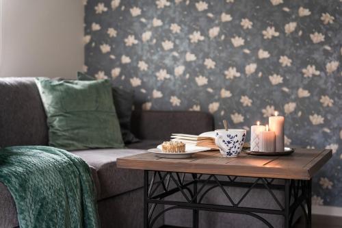 a living room with a couch and a table with candles at Guestly Homes - Charming 4BR Villa in central Piteå in Piteå