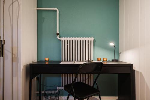 a desk with a chair and a radiator in a room at Guestly Homes - Charming 4BR Villa in central Piteå in Piteå