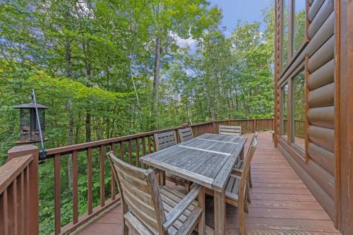 a wooden deck with a table and chairs on it at Our Place to Paws 4 Bd Lux Blue Ridge Mnt Cabin in Lansing