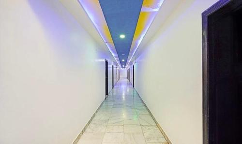a hallway in a building with a colorful ceiling at Hotel Bridge in Ahmedabad