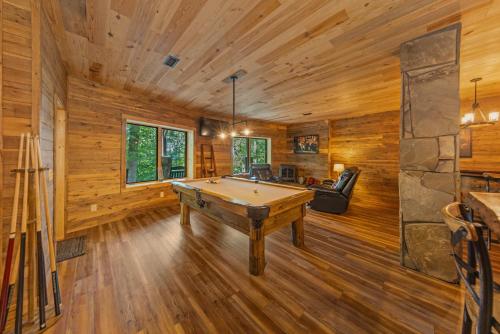 a pool table in a room with wooden walls at Our Place to Paws 4 Bd Lux Blue Ridge Mnt Cabin in Lansing