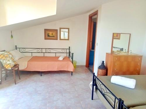 a bedroom with a bed and a dresser at Vista Alcantara - Wellness Mountain-Top Retreat in Motta Camastra