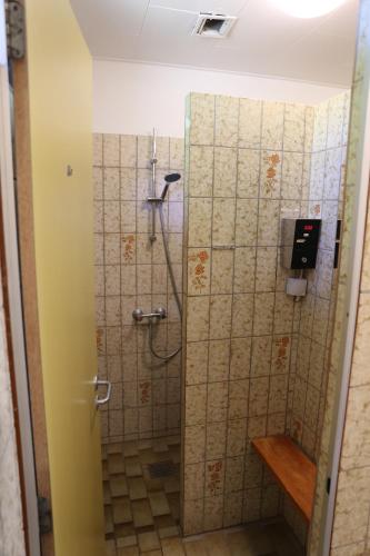 a bathroom with a shower with a glass door at Langeland Glamping in Rudkøbing