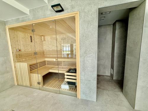 a sauna in a room with a glass wall at Rezydencja Niechorze D301 Boho Studio z Basenem i SPA - 5D Apartments in Niechorze