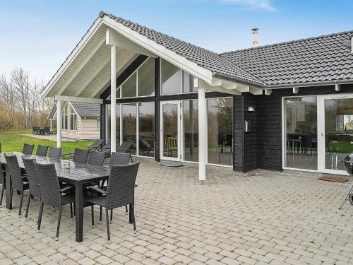 a patio with a table and chairs and a building at 16 person holiday home in Hasselberg in Kappeln
