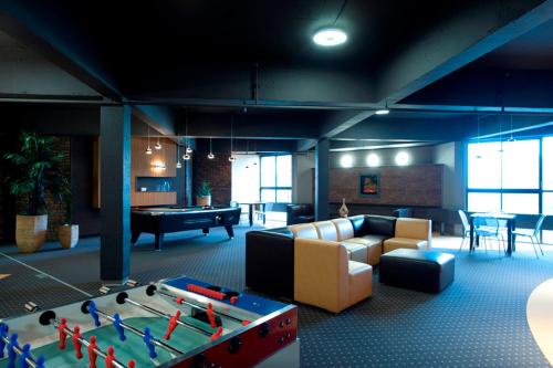 a living room with a ping pong table at ZUM MTL Auberge d'été - Université de Montréal in Montréal