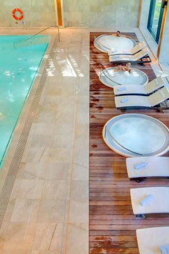 a row of toilets sitting next to a swimming pool at Eva Park Life & Spa in Konstancin-Jeziorna