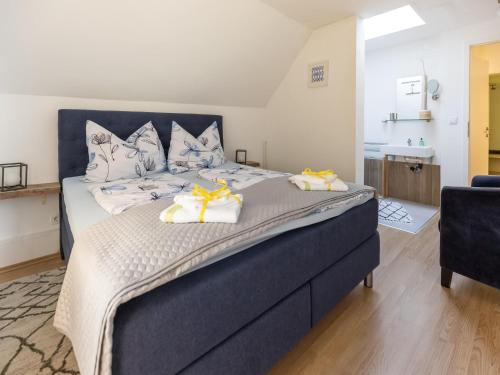 a bedroom with a large bed with towels on it at Apartment Feld am See near Ski Slopes in Feld am See