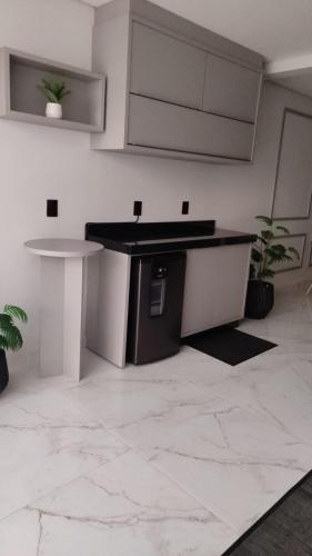 a kitchen with a counter and a table in a room at Apartamento Piratuba Alegria, 104 in Piratuba