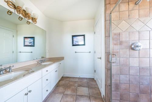 a bathroom with two sinks and a shower at Atlantic Paradise in Southern Shores