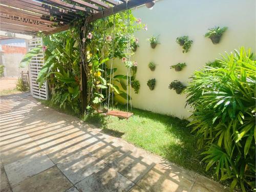 a garden with plants on the side of a building at Recanto Maria Flor by Holiday Stays in Flecheiras
