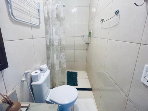 a white bathroom with a toilet and a shower at Recanto Maria Flor by Holiday Stays in Flecheiras