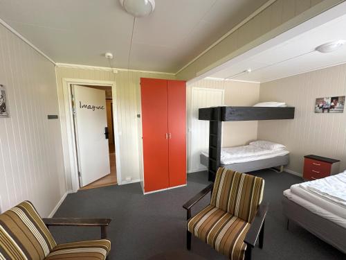 a room with a bed and a bunk bed at Karivollen Overnatting in Melhus