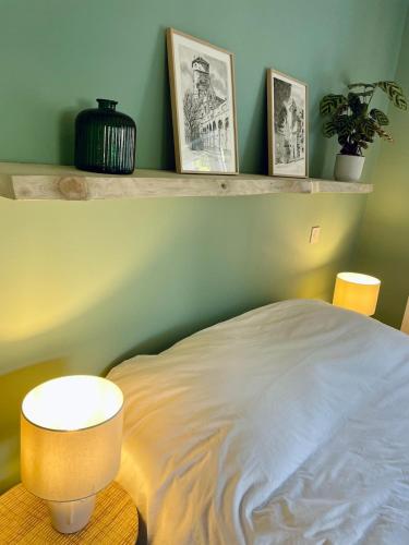 a bedroom with a bed and a table with a lamp at Maison climatisée 3 chambres avec jardin in Pontenx-les-Forges