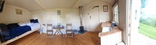 a bedroom with a bed and a table in a room at Jay in Priston