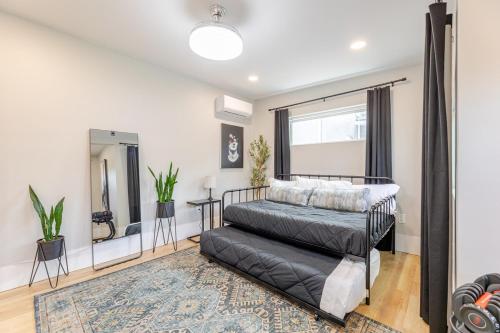 a bedroom with a bed and a mirror at NEW REMODEL Denver Luxury Home with Private HOT TUB in Denver