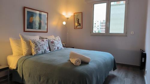 a bedroom with a bed with a hat on it at Port Royal in Aix-en-Provence