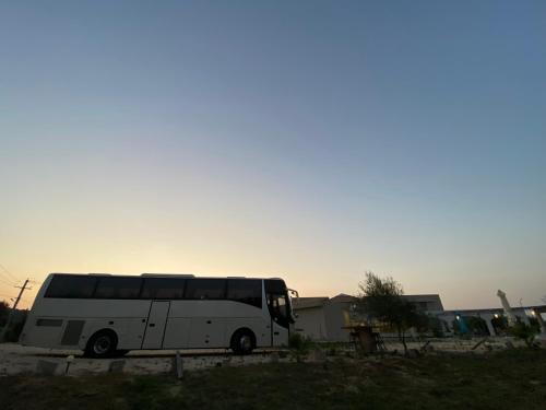 a white bus parked in a parking lot at Vians Olympia Resort in Olympia