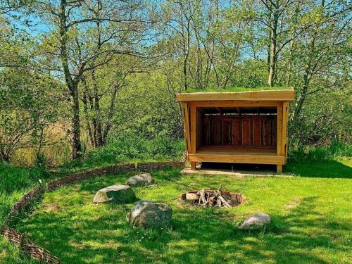 a wooden shelter in the middle of a field at 4 star holiday home in Rømø in Lakolk