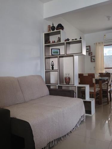 a living room with a couch and a dining room at Casa para COP30 in Marituba