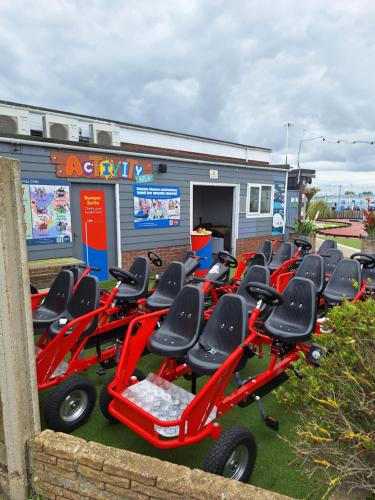 a row of red scooters parked in front of a building at Caravan at the seaside in Great Yarmouth