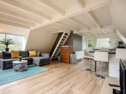 a living room with a couch and a table at Lanaken Lakeside Cabin Stay in Lanaken