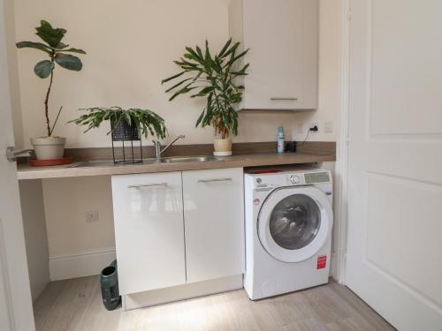 a white laundry room with a washing machine at 29 Ernest Dawes Avenue in Telford