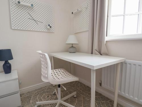 a white desk and a chair in a room at 29 Ernest Dawes Avenue in Telford