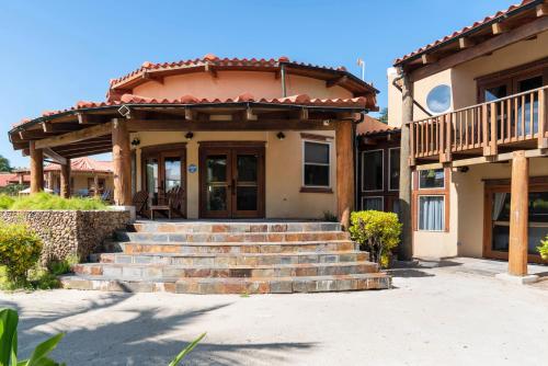 a house with stairs leading up to a porch at Seascape Villas in San Pedro