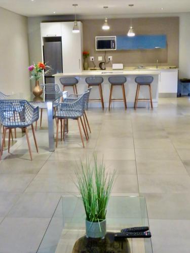 a lobby with chairs and a table and a counter at The Executive - Exclusive Self-Catering Apartments - Ezulwini in Ezulwini