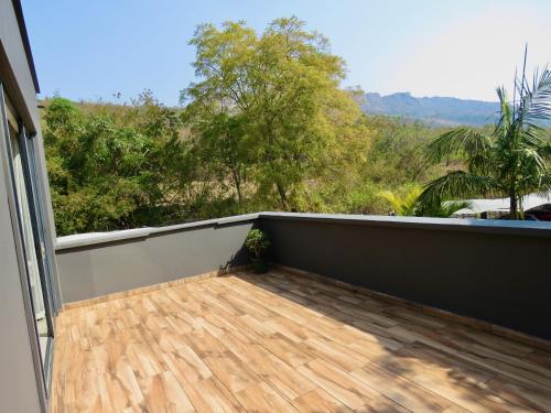 a balcony with a view of the jungle at The Executive - Exclusive Self-Catering Apartments - Ezulwini in Ezulwini